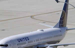 A United Airlines plane with the Continental Airlines logo on its tail, sits at a gate at O'Hare International airport in Chicago in this file photo taken on October 1, 2010. REUTERS/Frank Polich